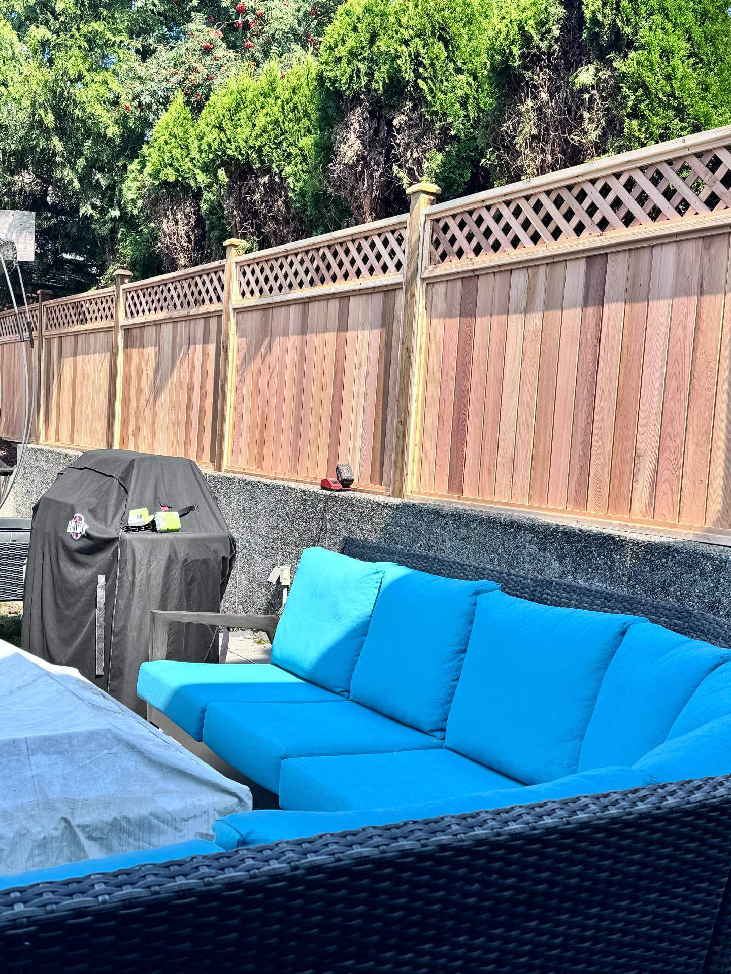 Cedar privacy fence with lattice top around a patio seating area