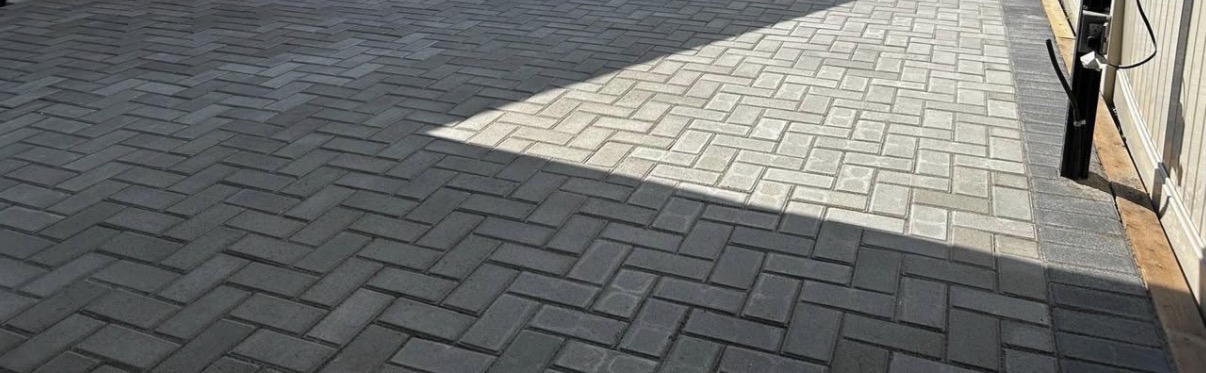 Charcoal herringbone paving stone driveway with contrasting border course