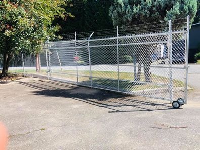 Galvanized chain link rolling gate on a commercial lot