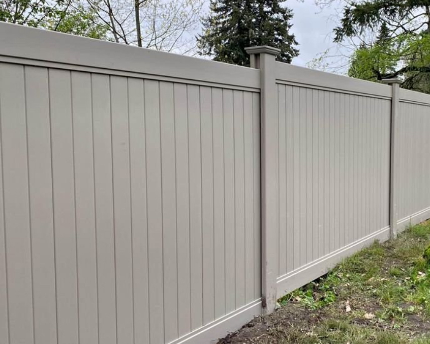 Tan vinyl privacy fence panels with post caps