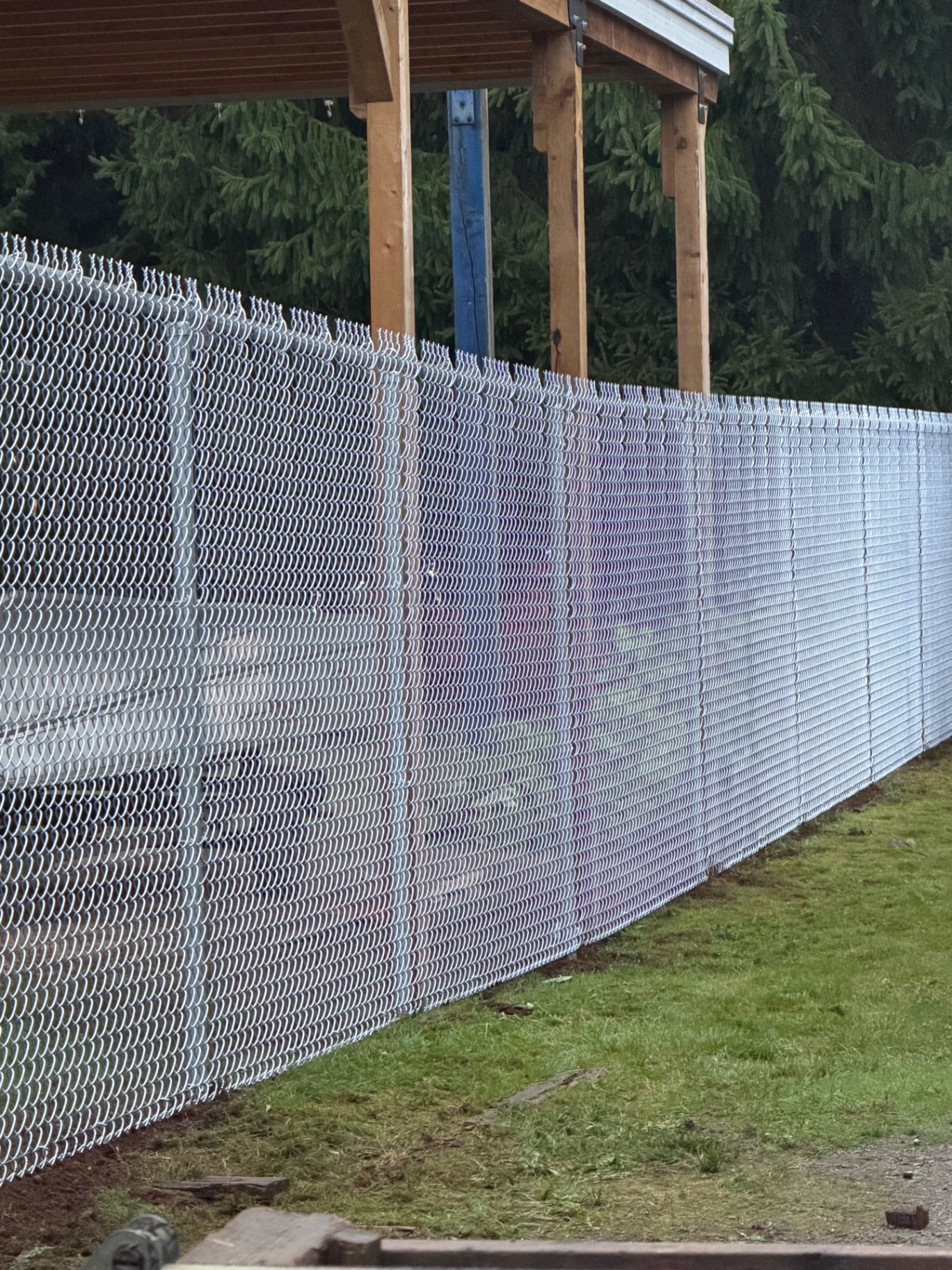 Close-up of a tightly stretched galvanized chain link fence mesh